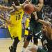 Michigan sophomore Tim Hardaway Jr. looks for possession of a loose ball around Ohio University sophomore T.J. Hall in the second half of the second round of the NCAA tournament at Bridgestone Arena in Nashville, Tenn.  Melanie Maxwell I AnnArbor.com